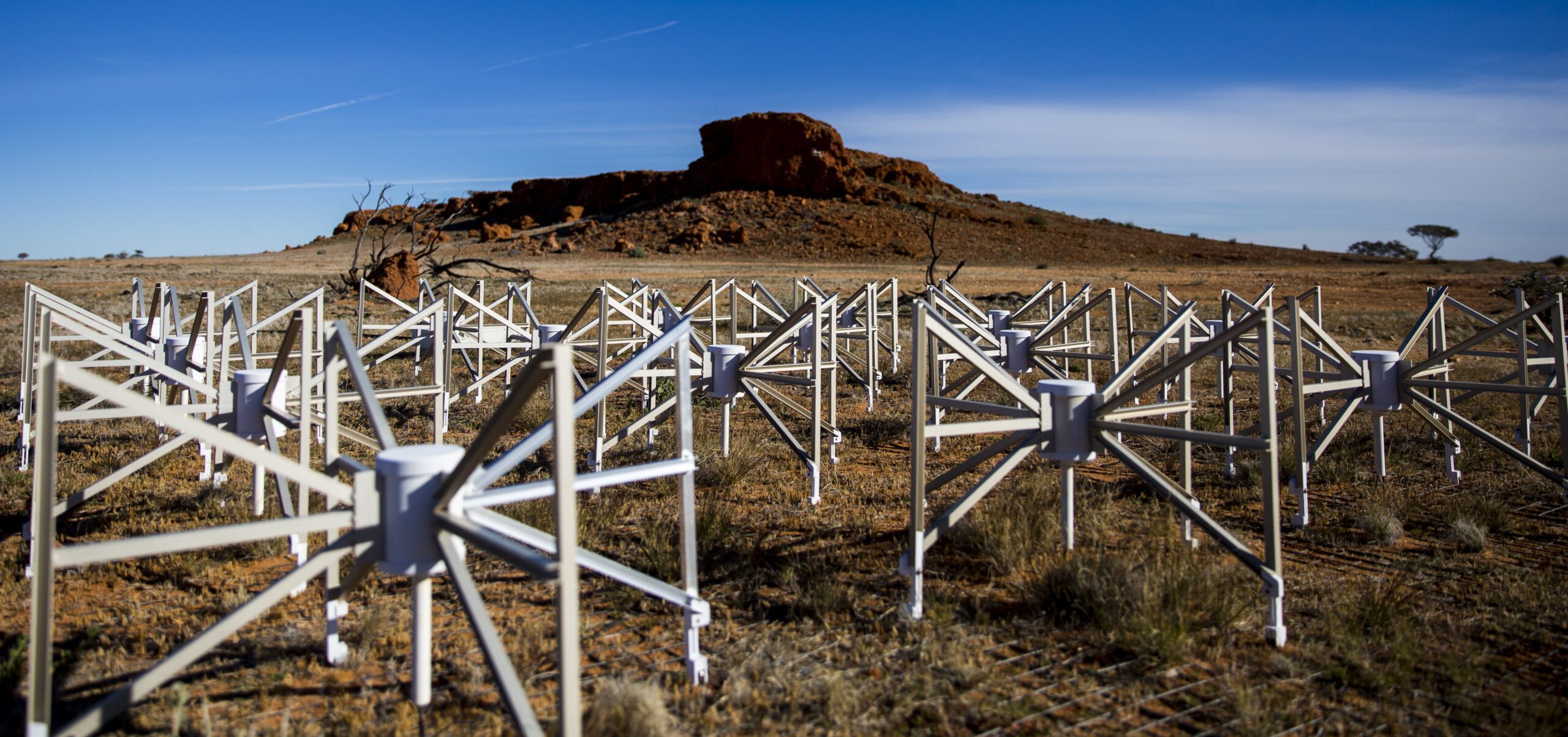 Spider-like astronomy equipment in a field.