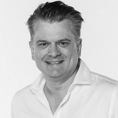 Black and white photo of man in white shirt.